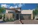 Modern single-story home with a stone accent wall, desert landscaping, and a two-car garage at 6747 N 9Th Dr, Phoenix, AZ 85013