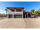 Front view of a two-story home with a balcony, three-car garage, and a paved driveway at 7030 N 181St Ave, Waddell, AZ 85355