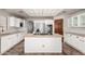 Kitchen with white cabinetry, tile flooring, center island, and stainless steel appliances at 7030 N 181St Ave, Waddell, AZ 85355