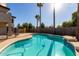 Inviting pool with palm trees and a wooden fence at 7030 N 181St Ave, Waddell, AZ 85355