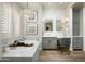 Modern bathroom with a soaking tub, dual vanities, and unique wall tiles at 9424 E Hidden Spur Trl, Scottsdale, AZ 85255