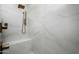 Luxurious shower with marble tile, gold fixtures, and a built-in bench at 9424 E Hidden Spur Trl, Scottsdale, AZ 85255