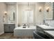 Elegant bathroom featuring a soaking tub, dual vanities, and stylish light fixtures at 9424 E Hidden Spur Trl, Scottsdale, AZ 85255