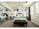 Stylish bedroom with designer accents, mirrored closet doors, and plush bedding at 9424 E Hidden Spur Trl, Scottsdale, AZ 85255