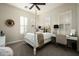 Charming bedroom with four-poster bed, shuttered windows, and neutral decor at 9424 E Hidden Spur Trl, Scottsdale, AZ 85255