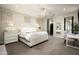 Bright bedroom with a large bed, ceiling fan, and workspace area at 9424 E Hidden Spur Trl, Scottsdale, AZ 85255