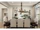 Elegant dining room with a unique antler chandelier, a large table, and stylish seating at 9424 E Hidden Spur Trl, Scottsdale, AZ 85255