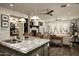 Granite kitchen island and stylish light fixtures offer views into an open living area at 9424 E Hidden Spur Trl, Scottsdale, AZ 85255