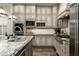 Bright kitchen boasts granite countertops, custom cabinetry, and stainless steel appliances at 9424 E Hidden Spur Trl, Scottsdale, AZ 85255