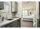 Small kitchenette area with sink, cabinetry, and view of bedroom at 9424 E Hidden Spur Trl, Scottsdale, AZ 85255