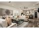 Open living room with comfortable seating, a coffee table, and views into the kitchen at 9424 E Hidden Spur Trl, Scottsdale, AZ 85255