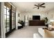 Living room with balcony access, a desk, and an ornate cabinet at 9424 E Hidden Spur Trl, Scottsdale, AZ 85255