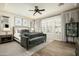 Spacious main bedroom with a ceiling fan, plush carpet, and large windows at 9424 E Hidden Spur Trl, Scottsdale, AZ 85255