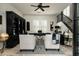 Sophisticated home office with dark wood furniture, built-in bookcase, and staircase at 9424 E Hidden Spur Trl, Scottsdale, AZ 85255