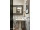 Elegant powder room with pedestal sink, marble accents, and stylish mirror at 9424 E Hidden Spur Trl, Scottsdale, AZ 85255
