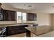 Kitchen with ample counter space, stainless steel appliances, and dark wood cabinets at 9536 E Travertine Ave, Mesa, AZ 85212