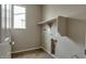 Spacious laundry room with overhead shelf and hookups at 9536 E Travertine Ave, Mesa, AZ 85212