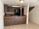 Kitchen features dark brown cabinets and black appliances at 122 S Hardy Dr # 42, Tempe, AZ 85281