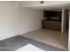 Open living room with gray carpeting and adjacent kitchen at 122 S Hardy Dr # 42, Tempe, AZ 85281