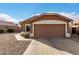 Single-story home with brown exterior and a two-car garage at 13727 W Marissa Dr, Litchfield Park, AZ 85340