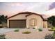 Single-story home with a two-car garage and desert landscaping at 1468 W Hopi Dr, Coolidge, AZ 85128