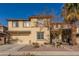 Two-story house with a three-car garage and desert landscaping at 15272 W Redfield Rd, Surprise, AZ 85379