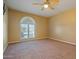 Spacious bedroom with arched window and ceiling fan at 1717 E Union Hills Dr # 1033, Phoenix, AZ 85024