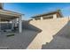 Backyard with covered patio and gravel at 17352 W Country Club Ter, Surprise, AZ 85387