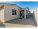 Covered patio and gravel backyard with block wall at 17352 W Country Club Ter, Surprise, AZ 85387