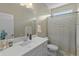 Clean bathroom with a white vanity and striped shower curtain at 17352 W Country Club Ter, Surprise, AZ 85387