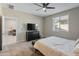 Well-lit bedroom with a comfortable bed and access to another room at 17352 W Country Club Ter, Surprise, AZ 85387