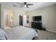 Comfortable bedroom with a TV and view into another room at 17352 W Country Club Ter, Surprise, AZ 85387