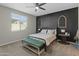Main bedroom with a cozy bed and dark accent wall at 17352 W Country Club Ter, Surprise, AZ 85387