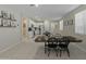 Kitchen and dining area with a farmhouse table and modern appliances at 17352 W Country Club Ter, Surprise, AZ 85387