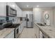 Modern kitchen with stainless steel appliances and granite countertops at 17352 W Country Club Ter, Surprise, AZ 85387