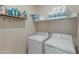 Laundry room with washer, dryer, and shelving for storage at 17352 W Country Club Ter, Surprise, AZ 85387