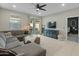 Bright living room with sectional sofa, and a view into adjacent bedroom at 17352 W Country Club Ter, Surprise, AZ 85387