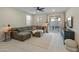 Living room with L-shaped sectional sofa and access to backyard patio at 17352 W Country Club Ter, Surprise, AZ 85387