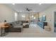 Spacious living room featuring a large sectional sofa and backyard access at 17352 W Country Club Ter, Surprise, AZ 85387