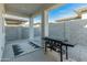 Covered patio with a Blackstone griddle and gravel flooring at 17352 W Country Club Ter, Surprise, AZ 85387
