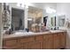 Bathroom with double vanity, wood cabinets and large mirror at 2135 N Heritage St, Buckeye, AZ 85396