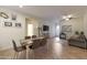 Dining room with a rustic wooden table and six brown leather chairs at 2135 N Heritage St, Buckeye, AZ 85396