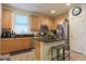 Kitchen with an island, stainless steel appliances, and wood cabinets at 2135 N Heritage St, Buckeye, AZ 85396