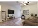 Living area with a sofa, TV, and access to a backyard patio at 2135 N Heritage St, Buckeye, AZ 85396