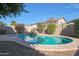 Relaxing kidney-shaped pool with a waterfall feature in a sunny backyard at 2135 N Heritage St, Buckeye, AZ 85396