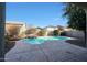 Relaxing kidney-shaped pool with waterfall feature in sunny backyard at 2135 N Heritage St, Buckeye, AZ 85396