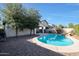 Inviting kidney-shaped pool, waterfall feature, and ample backyard space at 2135 N Heritage St, Buckeye, AZ 85396
