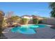Stunning kidney shaped pool with a waterfall feature and a pebble finish at 2135 N Heritage St, Buckeye, AZ 85396