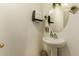 Clean bathroom with pedestal sink, mirror, and modern fixtures at 24018 W Wayland Dr, Buckeye, AZ 85326