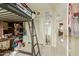 Bedroom with a loft bed, desk, and access to hallway at 24018 W Wayland Dr, Buckeye, AZ 85326